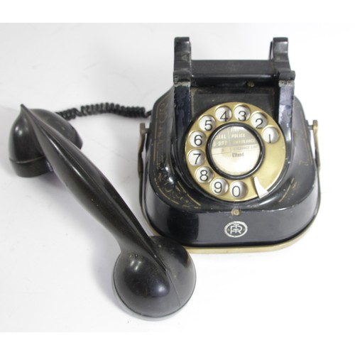 96 - An RTT Telephone, with brass carry handle, painted metal casing and Bakelite receiver, c1950s, paper... 