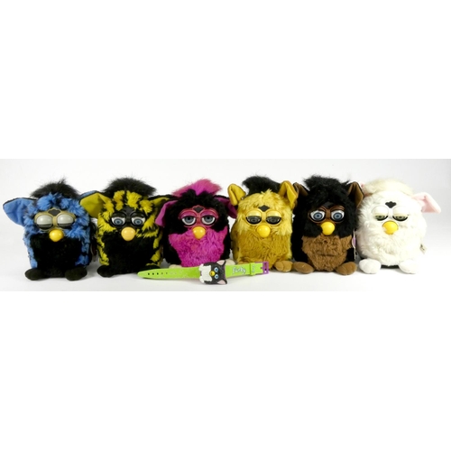 205 - Six Furbies, made by Tiger electronics, together with a Furby Carry Along backpack, with tags, also ... 