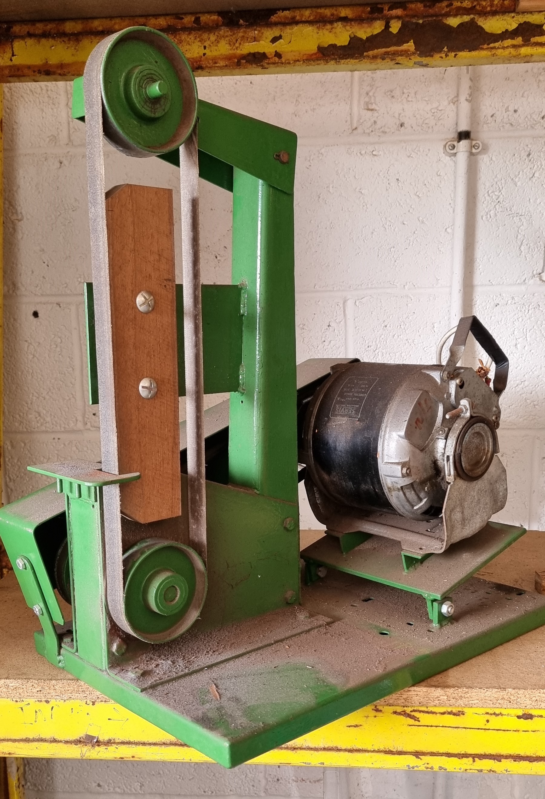 A bench mounted belt sander, 54cm high