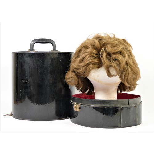 59 - Short, mid brown 1960's style wig in a black patent travel case , 35 x 27cm.
