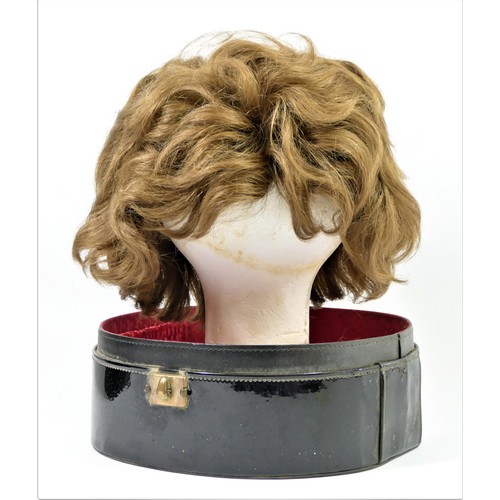 59 - Short, mid brown 1960's style wig in a black patent travel case , 35 x 27cm.