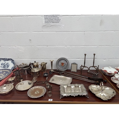 48 - A selection of silver plated items including a desk tidy, powder compact, coffee set etc.
