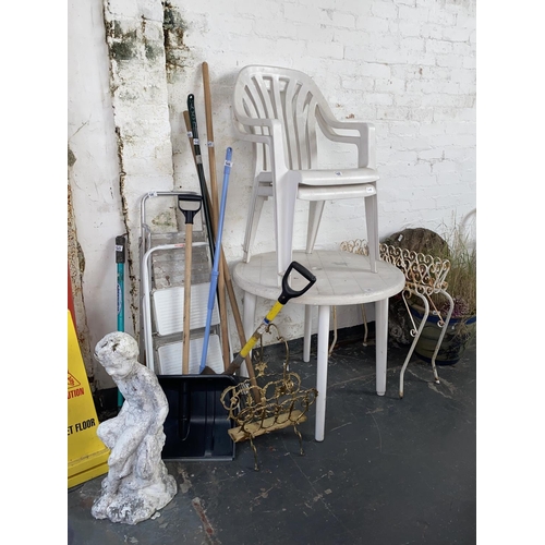 505 - Garden statues, table and two chairs, gardening tools etc.