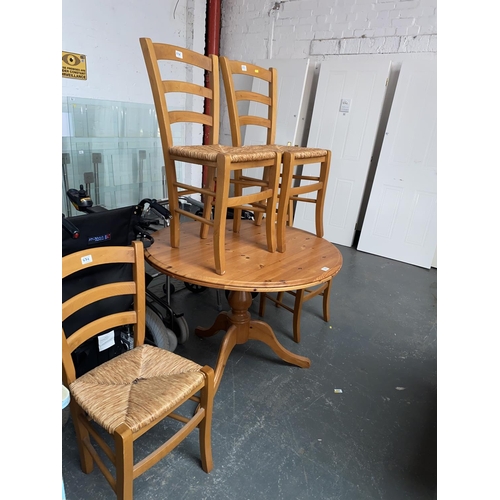 536 - A pine circular dining table and four chairs