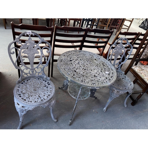 546 - A metal garden table and two chairs