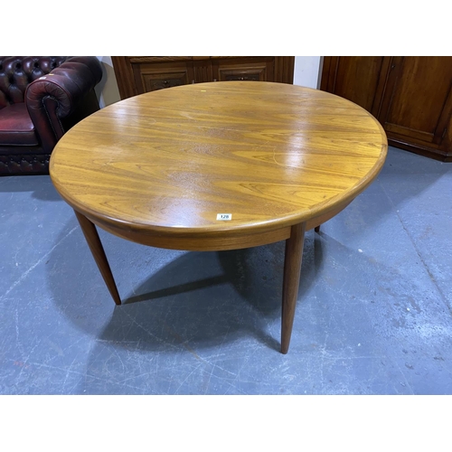 128 - A circular teak extending dining table