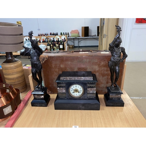 33 - A marble mantle clock/ garniture trio- spelter figures on marble bases and a vintage suitcase