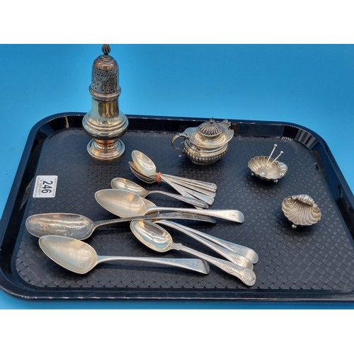 246 - Hallmarked silver sugar shaker, mustard pot, a pair of shell shaped salts and silver spoons