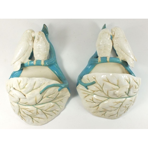 10 - A pair of 19th century Royal Worcester wall pockets with pairs of birds on leaves, 27cm