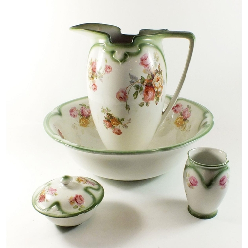 21 - A Burleighware toiletry set comprising jug and bowl, toothbrush mug and soap dish - printed flowers