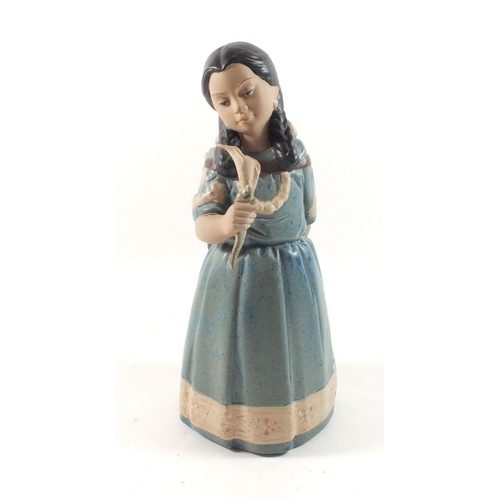 29 - A Nadal pottery figure of a girl
