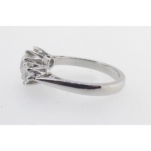 573 - A platinum three stone diamond ring, central stone measuring 1.20ct,   total estimated diamond weigh... 