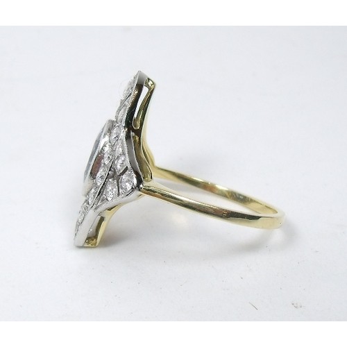 572 - An 18ct gold and platinum sapphire and brilliant cut diamond marquise shaped ring in pierced surroun... 