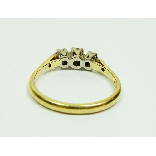 293 - An 18ct gold three stone diamond ring on diamond set shoulders, cased, Size N, 3g