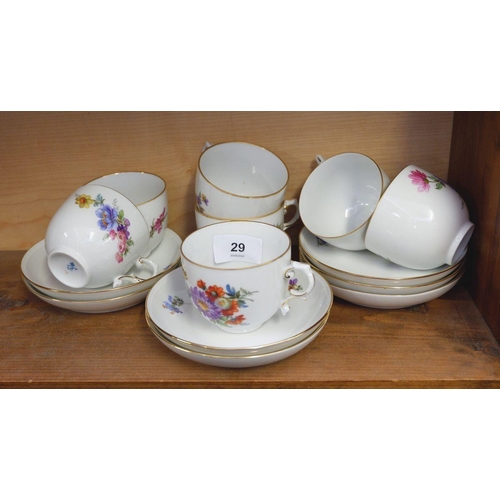 29 - A floral painted set of seven tea cups and saucers