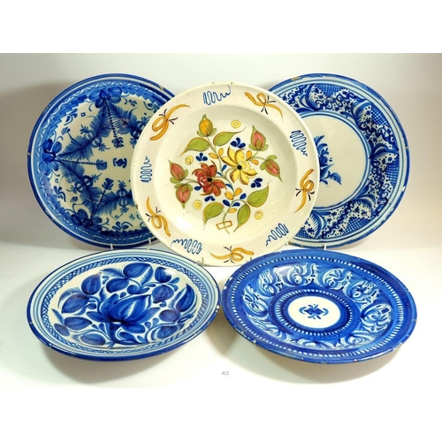 42 - A group of five tin glazed plates and charger, marked RC and VC, approx. 35 cm diameter