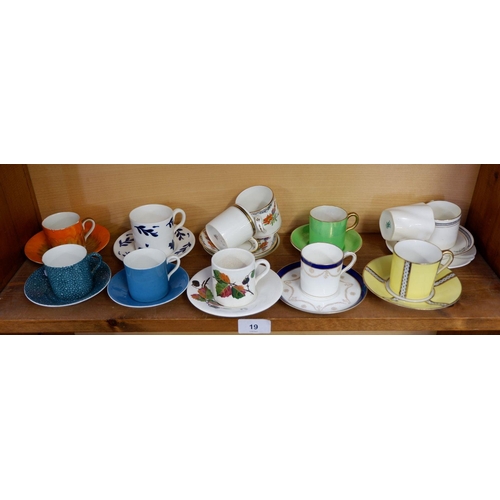 19 - A collection of twelve decorative coffee cans and saucers