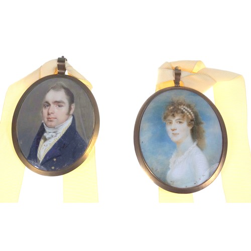 733 - Two Regency period oval portrait miniatures with locks of hair to reverse in matching brass oval fra... 