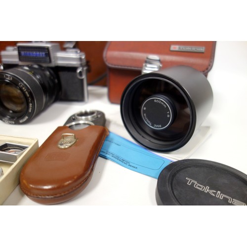 62 - A Nikkorex camera with zoom in original leather case, two Leica lenses, a Zeiss gauge, Leitz accesso... 