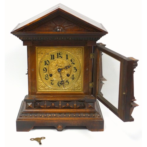 75 - A late Victorian oak bracket clock of architectural form with pointed pediment, fluted pillars on br... 