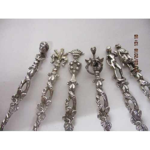 38 - A set of six silver coloured metal teaspoons with figural, bird, emblem finials, twisted and twig ef... 