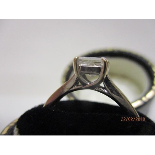 5 - An 18ct white gold ring set with a single princess cut diamond, flanked by ten diamonds to the shoul... 
