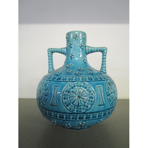 33 - A Burmantofts faience pottery, twin handled vase of compressed globular form with short narrow neck,... 