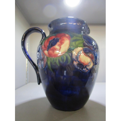 59 - Walter Moorcroft for Moorcroft pottery, an Anemone pattern blue ground jug, painted WM and stamped m... 