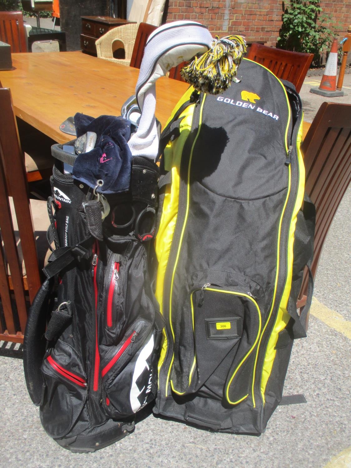 A set of golf clubs, together with a Golden Bear travel bag Location G