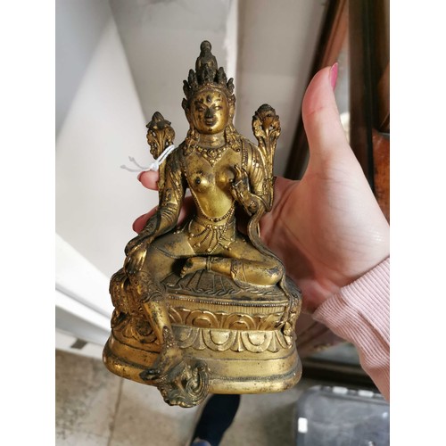 98 - A Sino Tibetan gilt bronze statue of Tara Bodhisattva seated in lalitasana, on an oval double lotus ... 