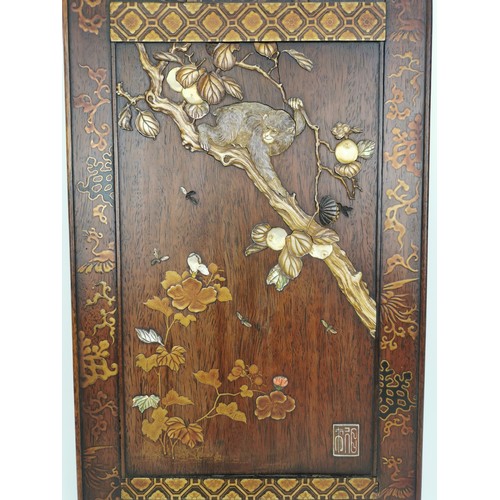 77 - A Japanese Meiji period shibayama inlaid lacquer wall hanging depicting a carved ivory inlaid monkey... 