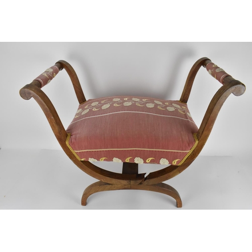 49 - A 19th century Biedermeier upholstered window seat or curule stool, with later upholstery, designed ... 