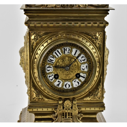 28 - A late 19th/early 20th century French brass mantle clock, the case having an acorn finial with embos... 