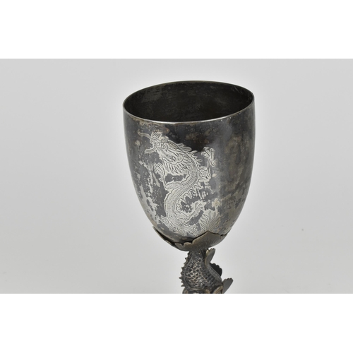 15 - A Chinese export silver goblet modelled with a dolphin stem on a circular base, the dolphin with det... 