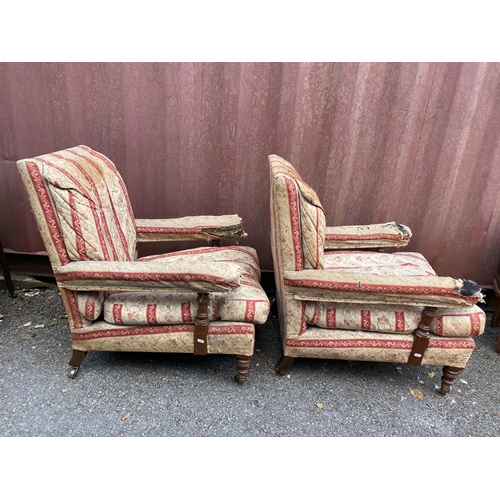 158 - A pair of late 19th century Howard & Son armchairs of low proportions having mahogany turned support... 