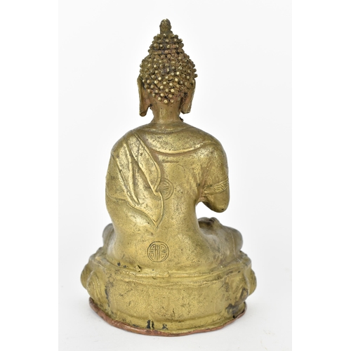 110A - A Tibetan statue of Buddha seated in Abhaya Mudra on a lotus base, base with copper cover with impre... 