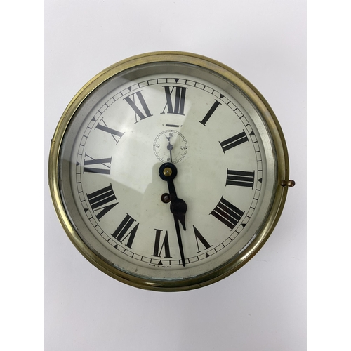 14 - An early/mid 20th century brass cased ships bulkhead clock, the 8 inch dial having Roman numerals wi... 