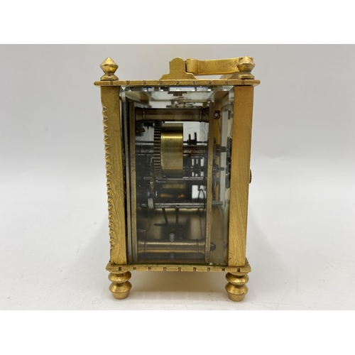 18 - An early 20th century square formed alarm carriage clock, the white enamel dial having Arabic numera... 