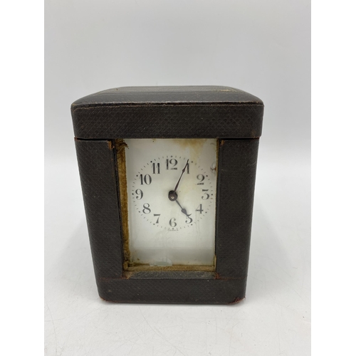 32 - An early 20th century French carriage clock having a white enamel dial with Arabic numerals and with... 