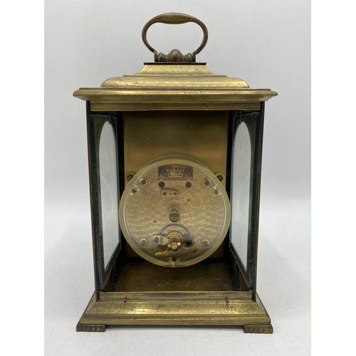 33 - A late 19th century brass cased mantle clock having a silvered dial with Roman numerals with pierced... 