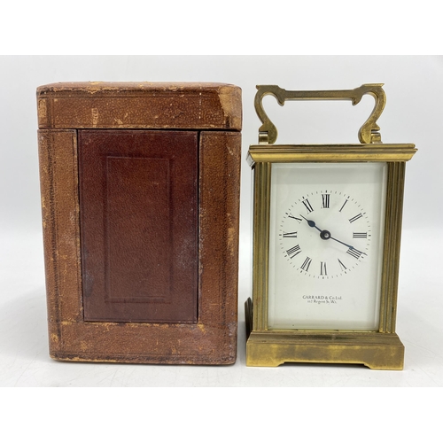 34 - An early 20th century carriage clock with travel case, retailed by Garrard & Co, the white enamel di... 