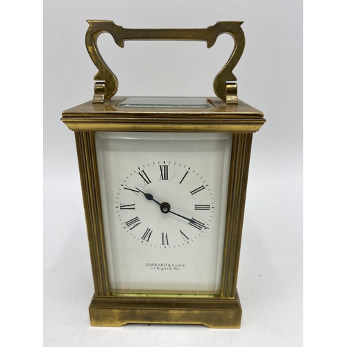34 - An early 20th century carriage clock with travel case, retailed by Garrard & Co, the white enamel di... 