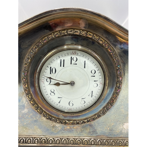 36 - A circa 1900 silver plated mantle clock, possibly by Liberty & Co, the white enamel dial having Arab... 