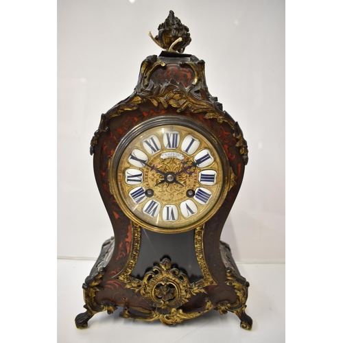 11 - A late 19th century French Boulle mantle clock, the red tortoiseshell case having a metal basket of ... 