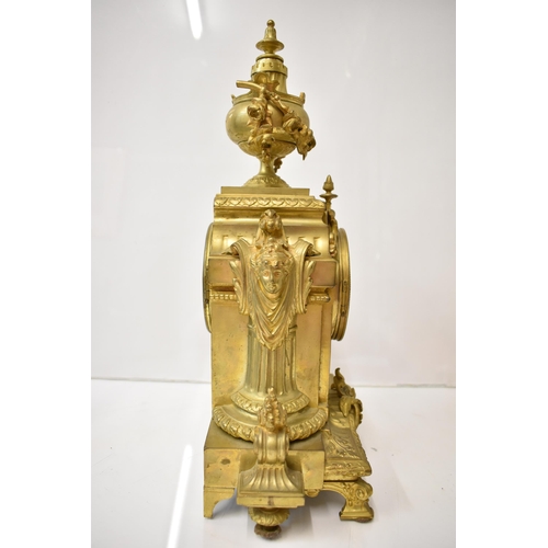 12 - A 19th century French gilt metal mantel clock, the case having an urn shaped finial with floral swag... 