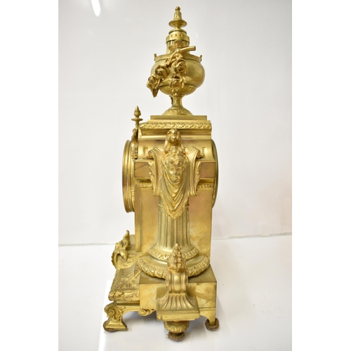 12 - A 19th century French gilt metal mantel clock, the case having an urn shaped finial with floral swag... 