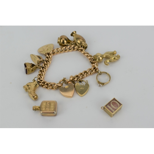 A 15ct gold curb link bracelet with a padlock style clasp, ten 9ct gold charms, 42g and a gold plated charm