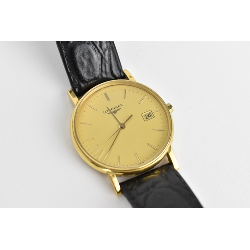 56 - A Longines 18ct gold cased Quartz wristwatch having baton hour markers with central seconds and date... 