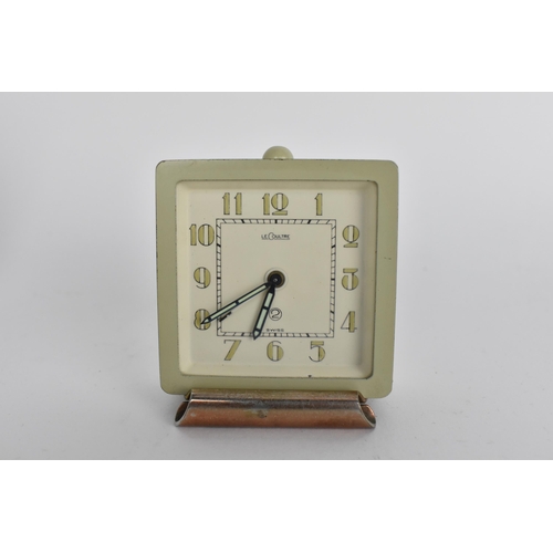50A - An Art Deco LeCoutre bedside travel/desk alarm clock in a metal case, the dial having Arabic numeral... 