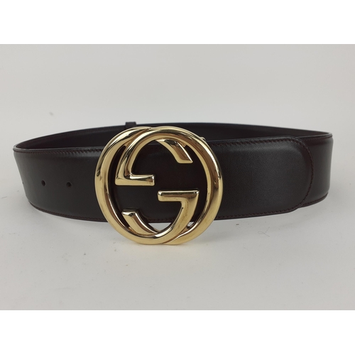 Gucci- A brown leather belt with interlocking GG gold tone buckle, 3 holes, Made in Italy, 28" waist (70cm). The size of the buckle is approximately 7" diameter
Location: RWB